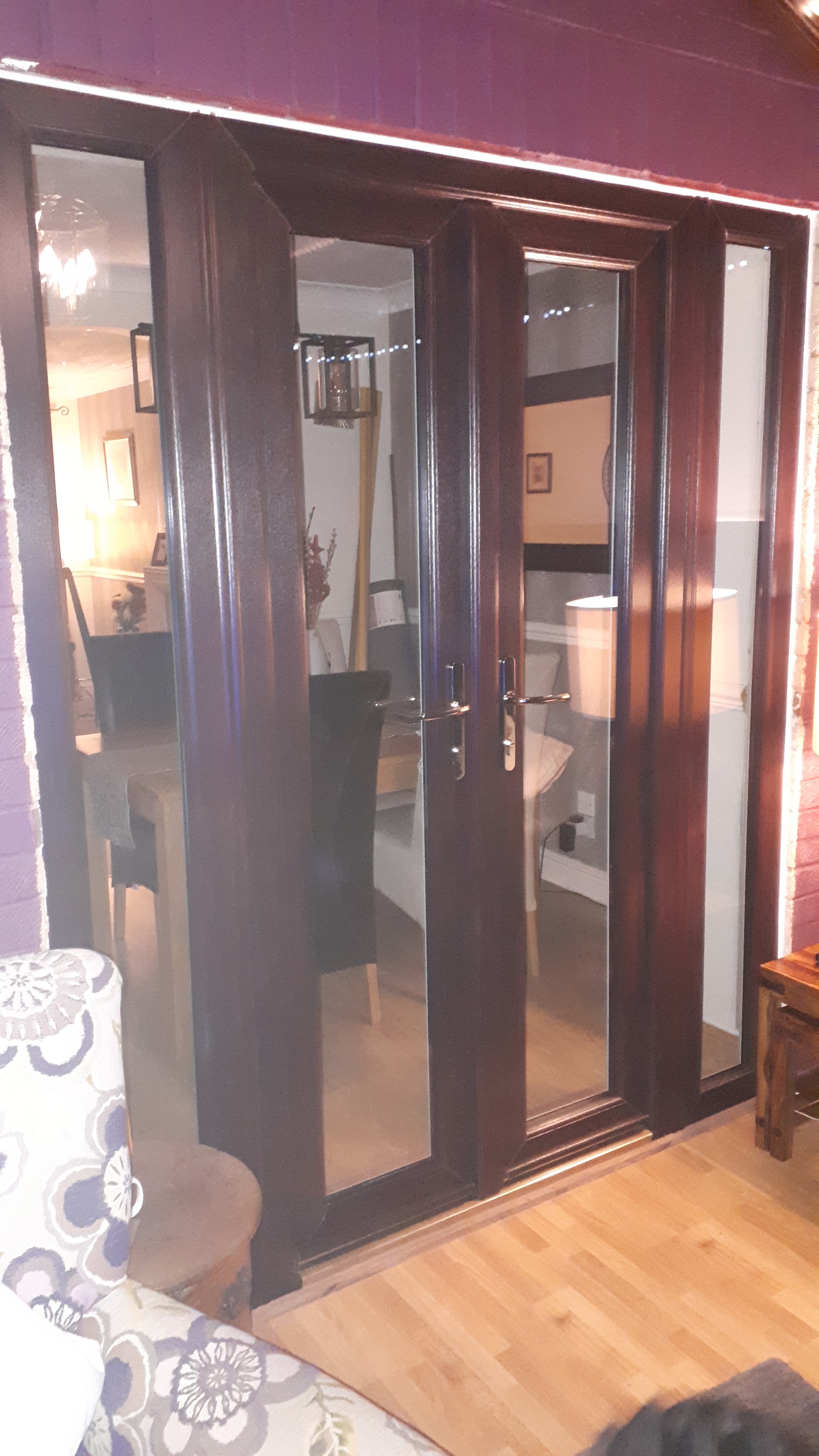 Dark brown patio doors seen from inside a conservatory